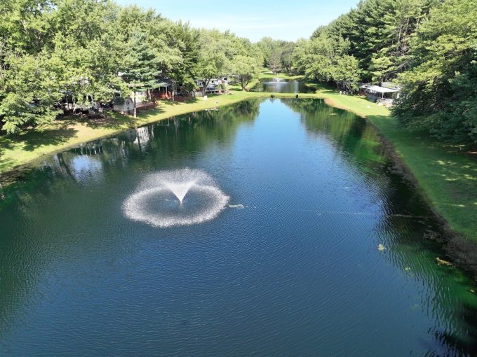 Picturesque view of the pond, trees and RV sites at Stand Rock Campground