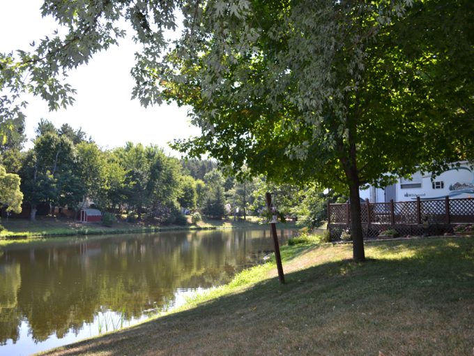 Picturesque view of the pond, trees and RV sites at Stand Rock Campground