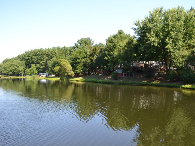 Picturesque view of the pond, trees and RV sites at Stand Rock Campground
